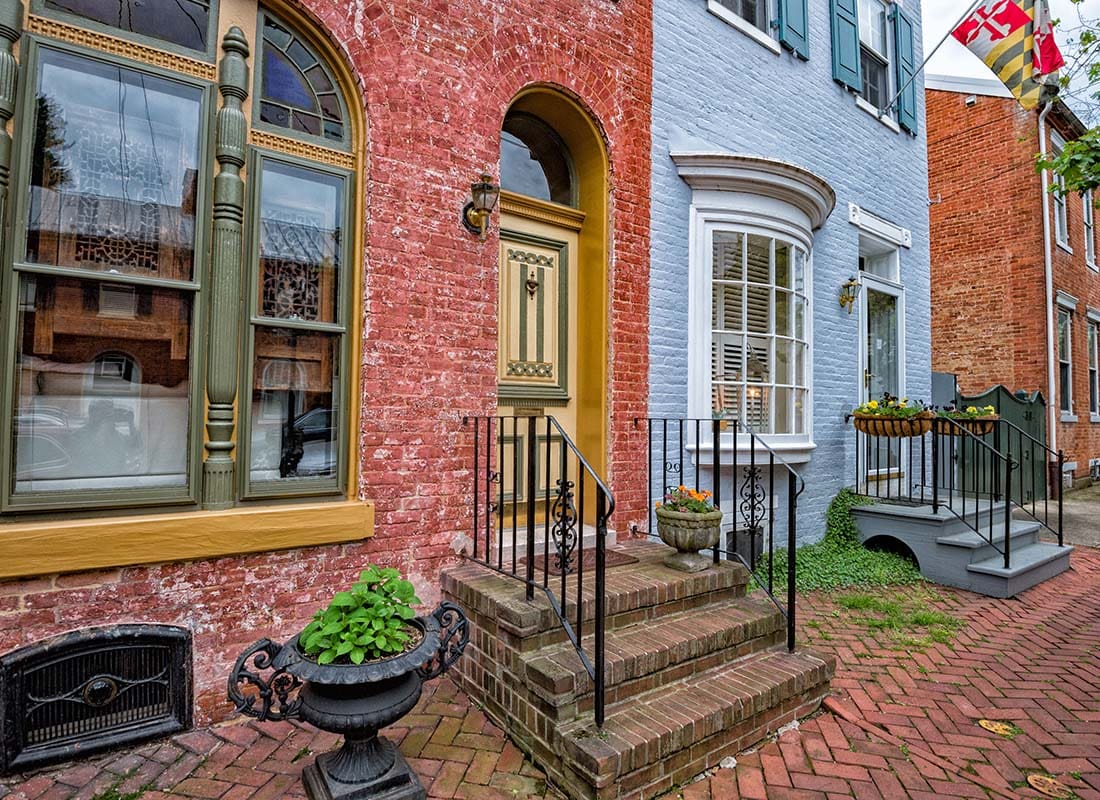Insurance Solutions - Row of Historical Brick Homes in Downtown Frederick Maryland with a Red Paved Sidewalk Out Front