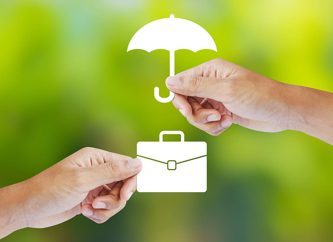 Commercial Umbrella Insurance - Closeup View of a Hand Holding an Umbrella Over Another Hand Holding a Suitcase Against a Bright Green Background