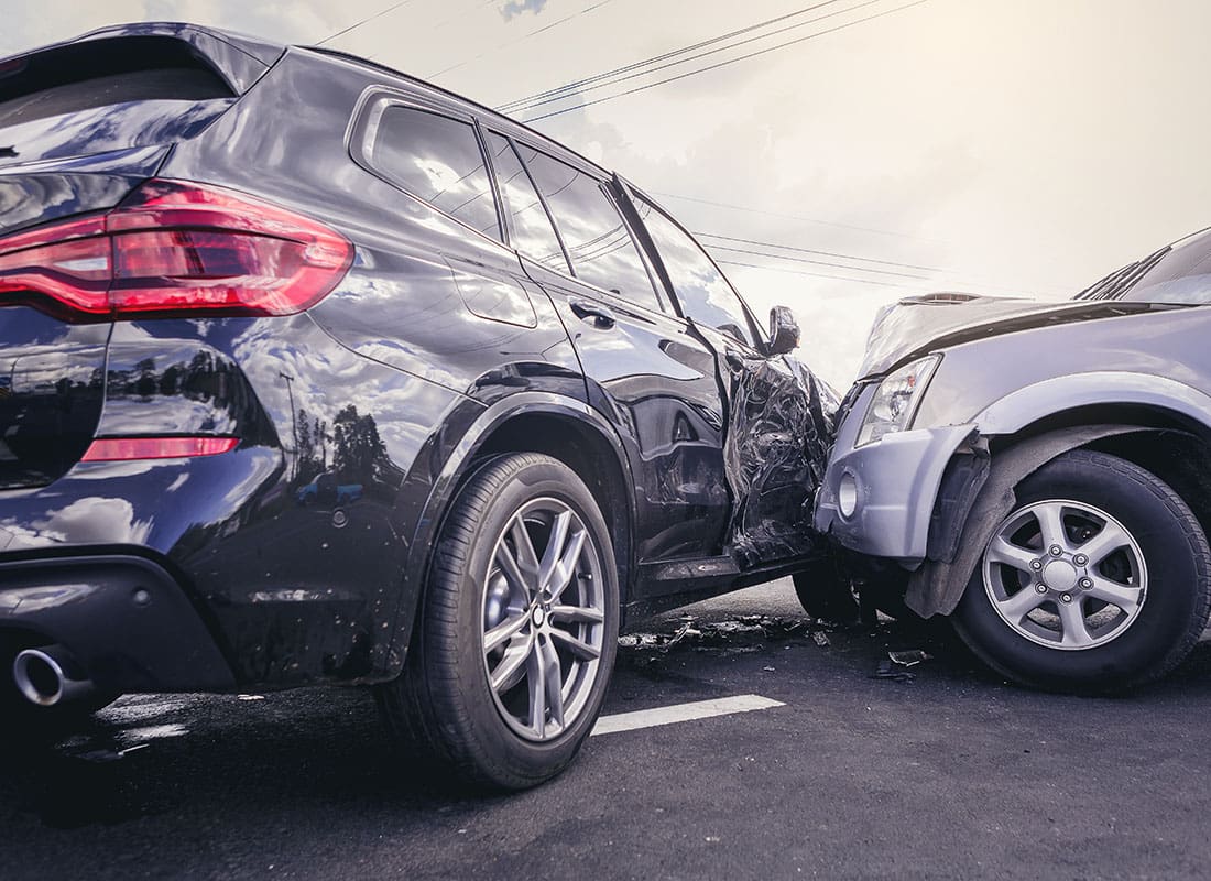 Report a Claim - View of Two SUV Cars Involved in a Front Car Collision Accident